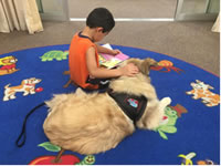 Child reading to dog