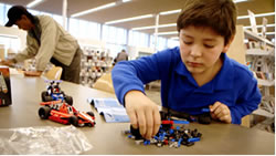 Child playing with robot